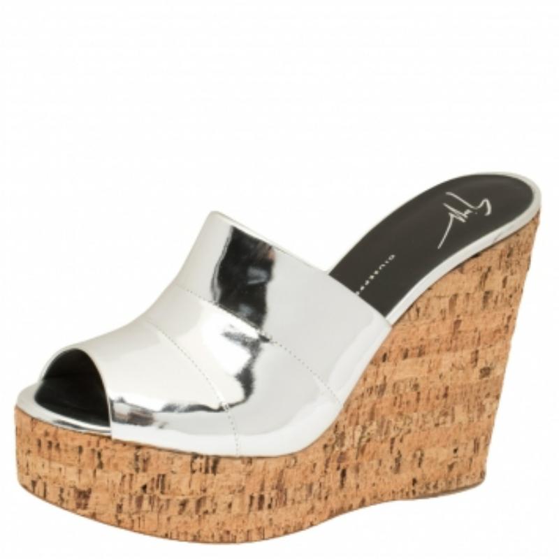 Stylish, comfortable, and versatile, these Giuseppe Zanotti sandals are a must-have! These lovely wedge slides will bring you the right amount of style and comfort. They feature a leather strap in metallic silver across the vamps and 13 cm cork