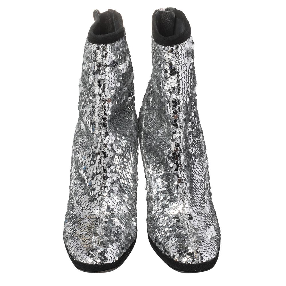 Giuseppe Zanotti's collections are a testament to the label's opulent and glamorous aesthetics. These ankle boots are covered with silver sequins that make them ideal for parties and special events. They are secured with zippers and raised on 10 cm
