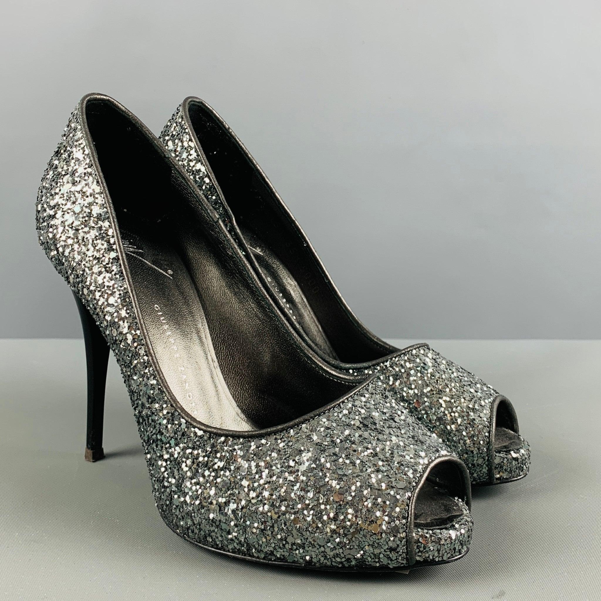 GIUSEPPE ZANOTTI pumps comes in a silver glitter material featuring an open toe, stone encrusted look, stiletto heels. Made in Italy.Very Good Pre-Owned Condition. 

Marked:   0651 35 1/2 5000 

Measurements: 
  Heel: 4.25 inches Platform: 0.5