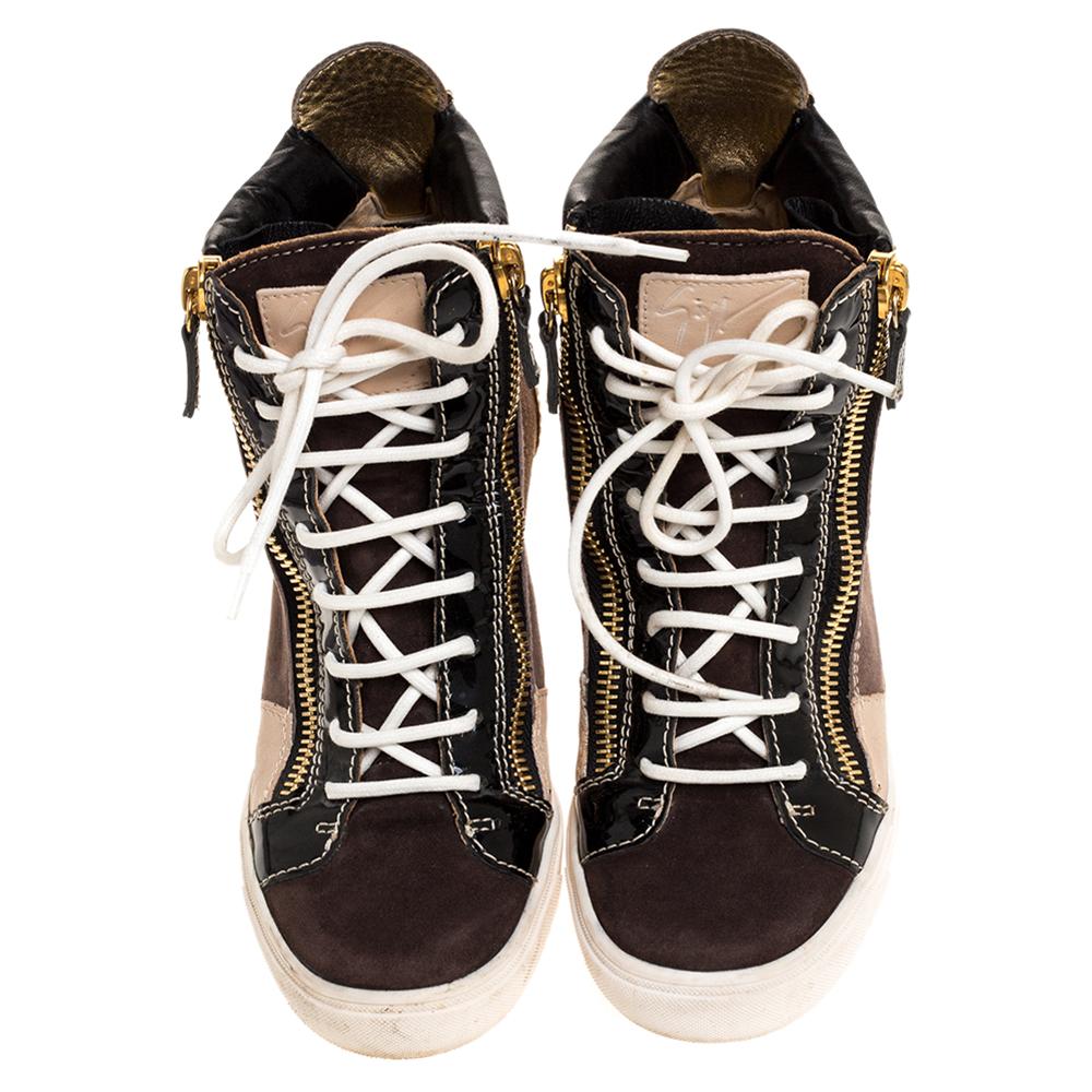 Comfort comes wrapped in these sneakers from Giuseppe Zanotti. They are crafted from suede as well as leather and they bring details of lace-ups and zippers. Elevated on wedge heels, these sneakers are easy to wear all day without compromising on