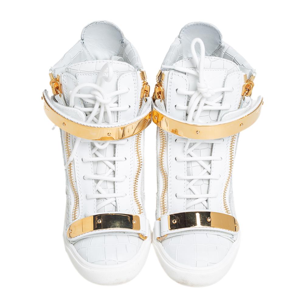 These sneakers by Giuseppe Zanotti are meant to be flaunted. Crafted from crocodile-embossed leather, they feature a gorgeous design of gold-tone zipper details on the front and at the rear. The pair is beautifully completed with concealed wedges