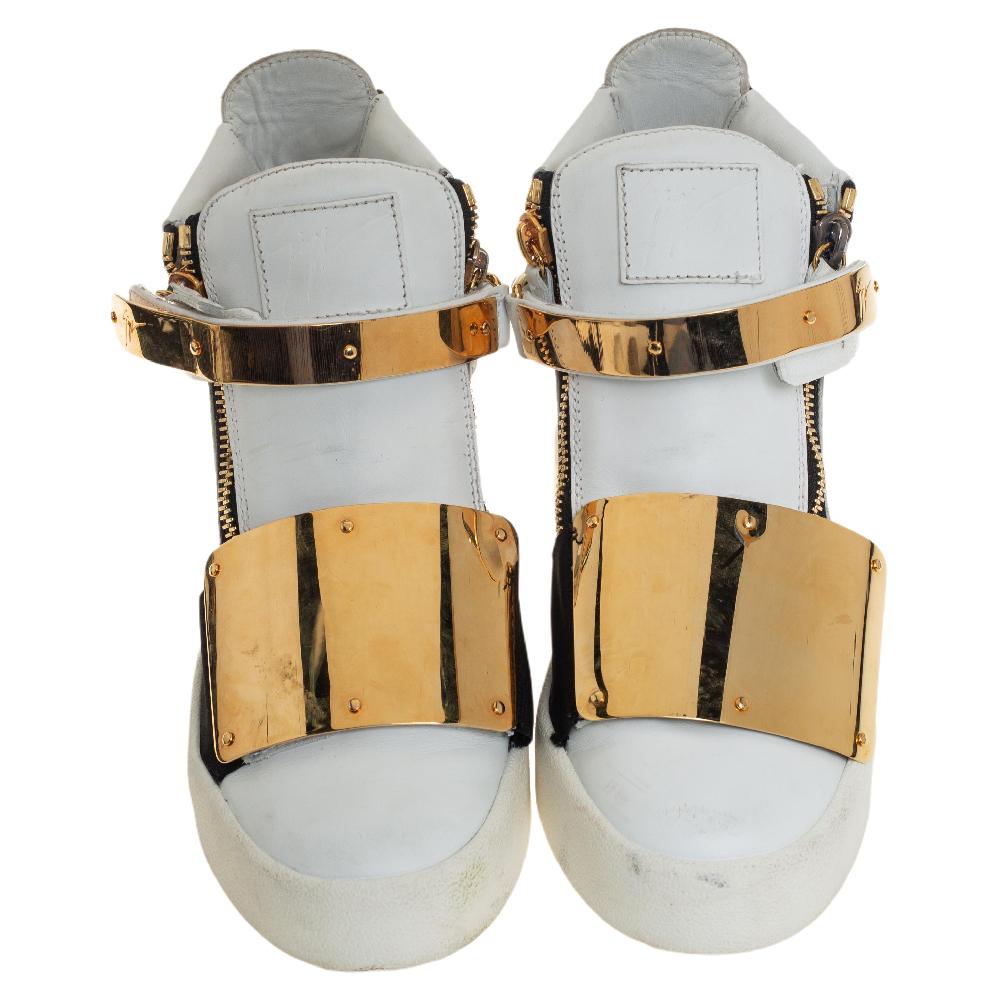 These high-top sneakers from Giuseppe Zanotti are gorgeous. They have been crafted from white leather and detailed with gold-tone metal straps on the uppers, double zippers on the sides, brand logos on the tongues, and single zippers on the heel