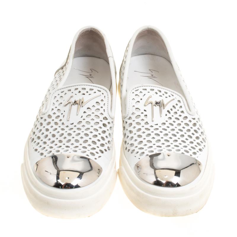 Ace your sneaker game with this amazing pair from Giuseppe Zanotti. The white Skate sneakers are crafted from leather and feature a perforated design. They flaunt round silver-tone metal cap toes, leather lined insoles and solid rubber soles that
