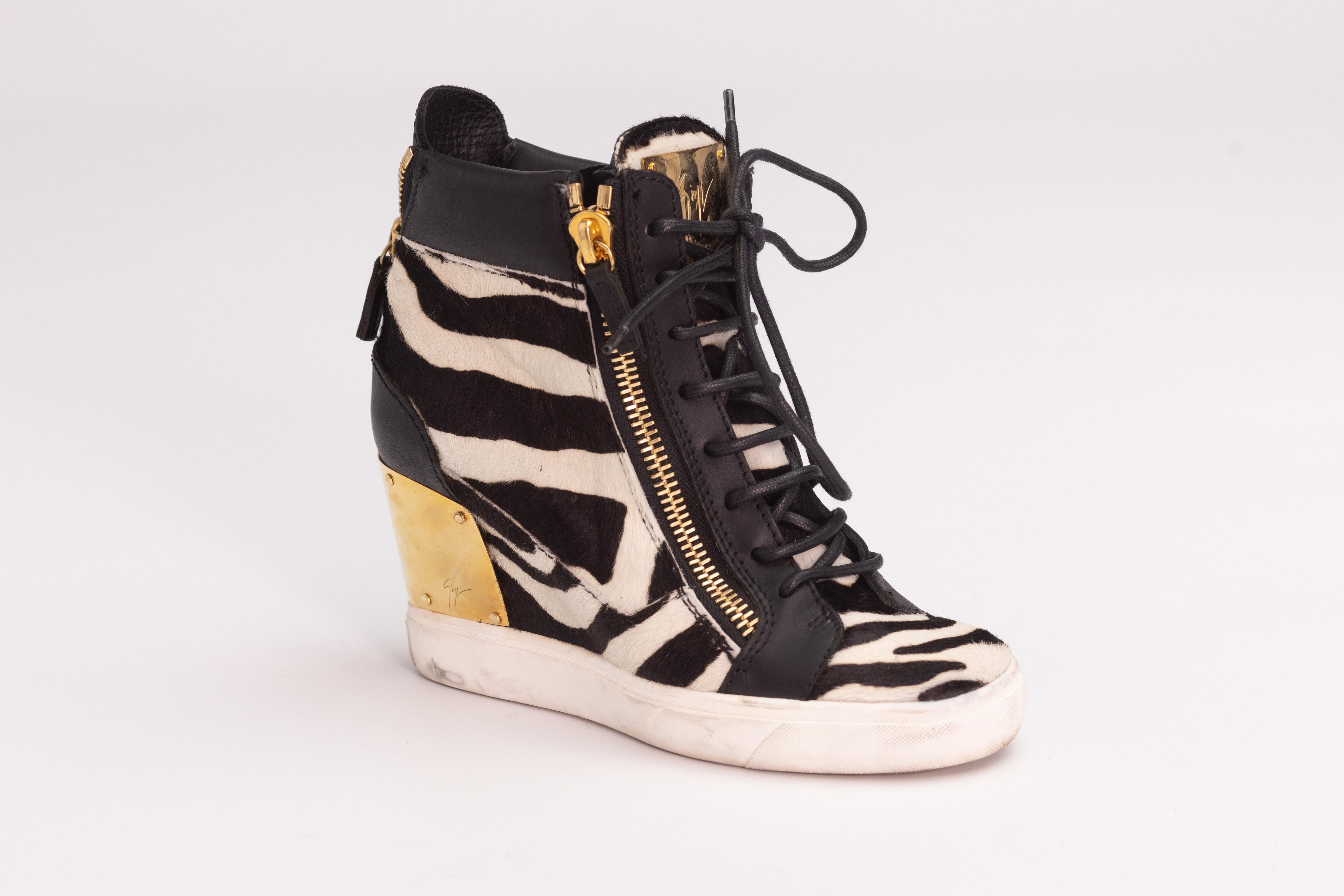Color: Black and white zebra print with gold detail on heel
Material: Leather , calf hair and metal plate at heel
Size: 36 EU / 5 US
Wedge Height: 75 mm / 3”
Condition: Good. Scratches to the plate. Dislocation and makes throughout. 
Comes with: