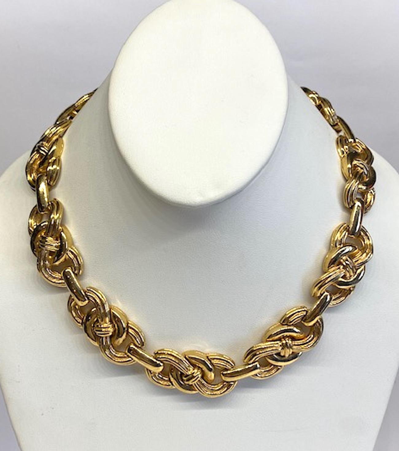 Givenchy 1980s necklace in gold tone links. Triple smooth and ribbed loop links are connected to create this beautiful classic chain necklace. The nine loop links are .75 of an inch wide and 1.63 inches long. The extender chain is 2.5 inches long