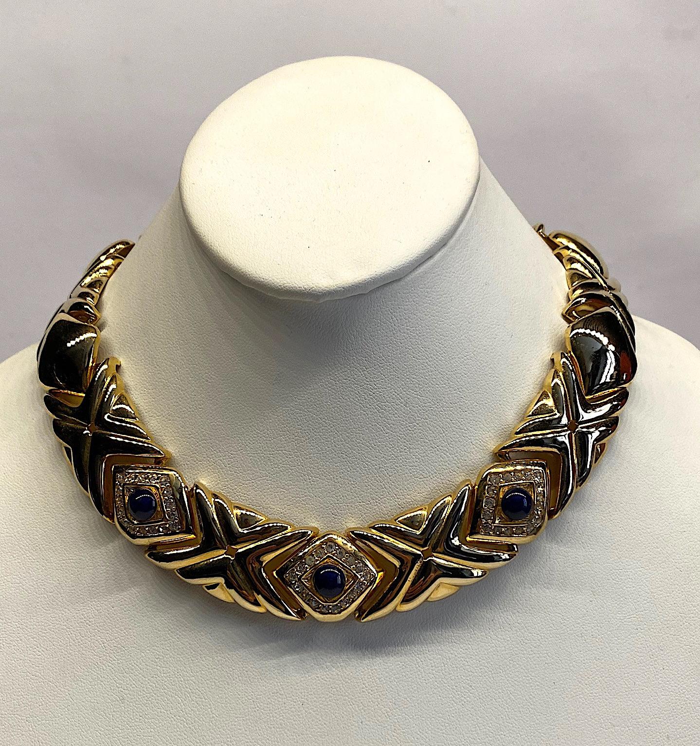 A chic tailored style Givenchy necklace from the 1980s. There are two different style links. One is a plain diamond shaped and the other is a larger elongated X shape design. The from three diamond links have a navy blue cabochon stone surrounded by