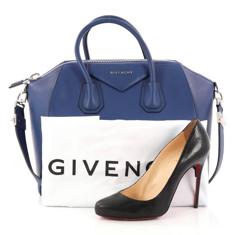 This authentic Givenchy Antigona Bag Leather Medium is a go-to fashion favorite. Crafted from blue leather, this structured yet stylish tote features dual-rolled leather handles and silver-tone hardware accents. Its zip closure opens to a beige