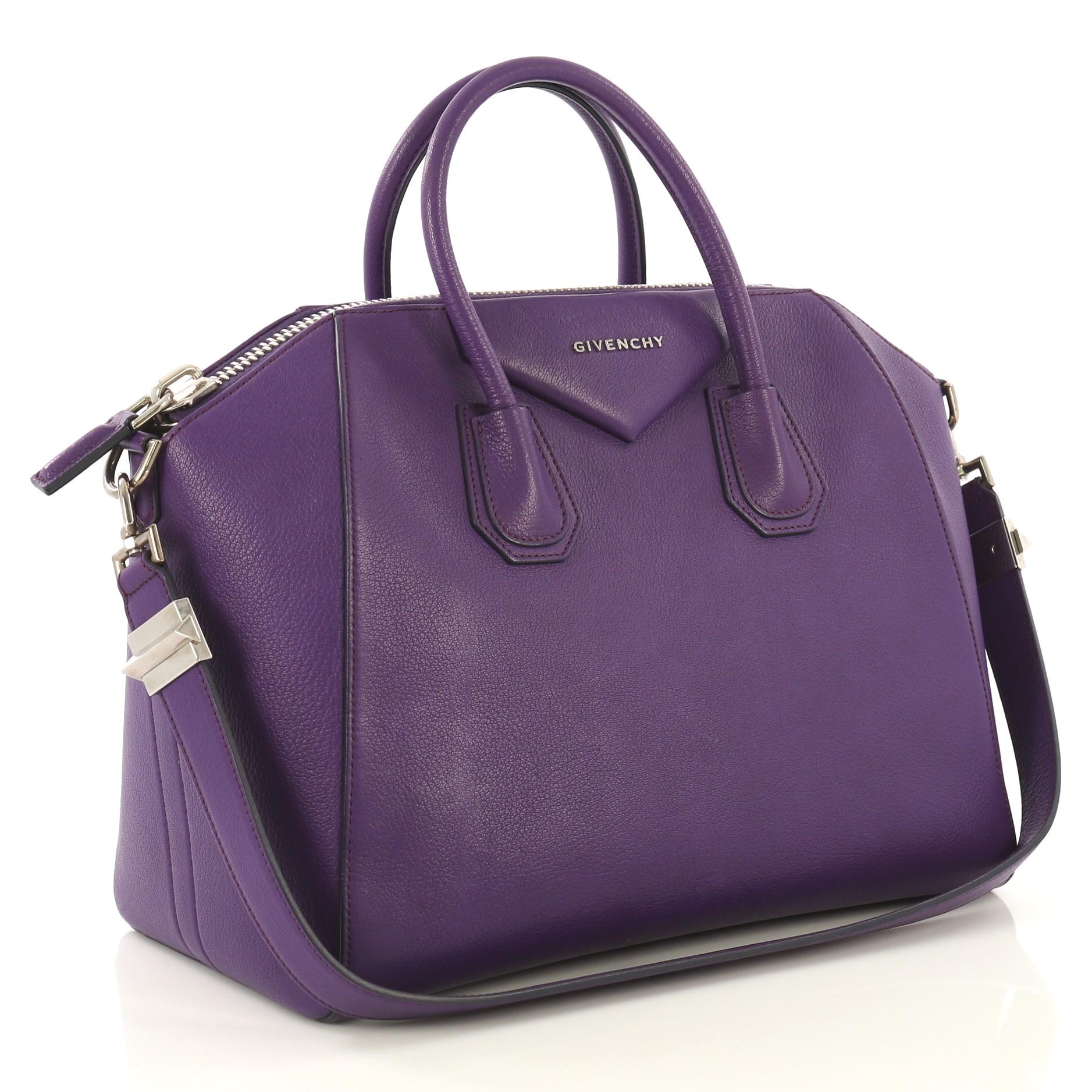This Givenchy Antigona Bag Leather Medium, crafted from purple leather, features dual rolled leather handles and silver-tone hardware. Its zip-around closure opens to a beige fabric interior with zip and slip pockets. 

Estimated Retail Price: