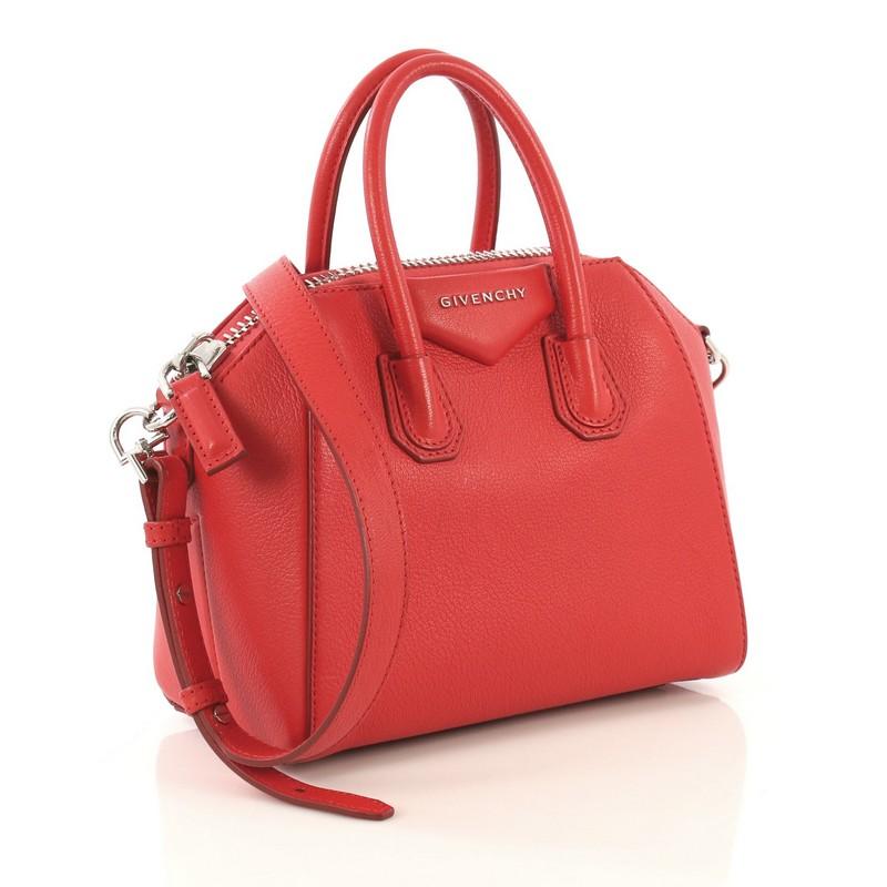 This Givenchy Antigona Bag Leather Mini, crafted from red leather, features dual rolled leather handles and silver-tone hardware. Its zip-around closure opens to a black fabric interior with zip and slip pockets.

Estimated Retail Price: