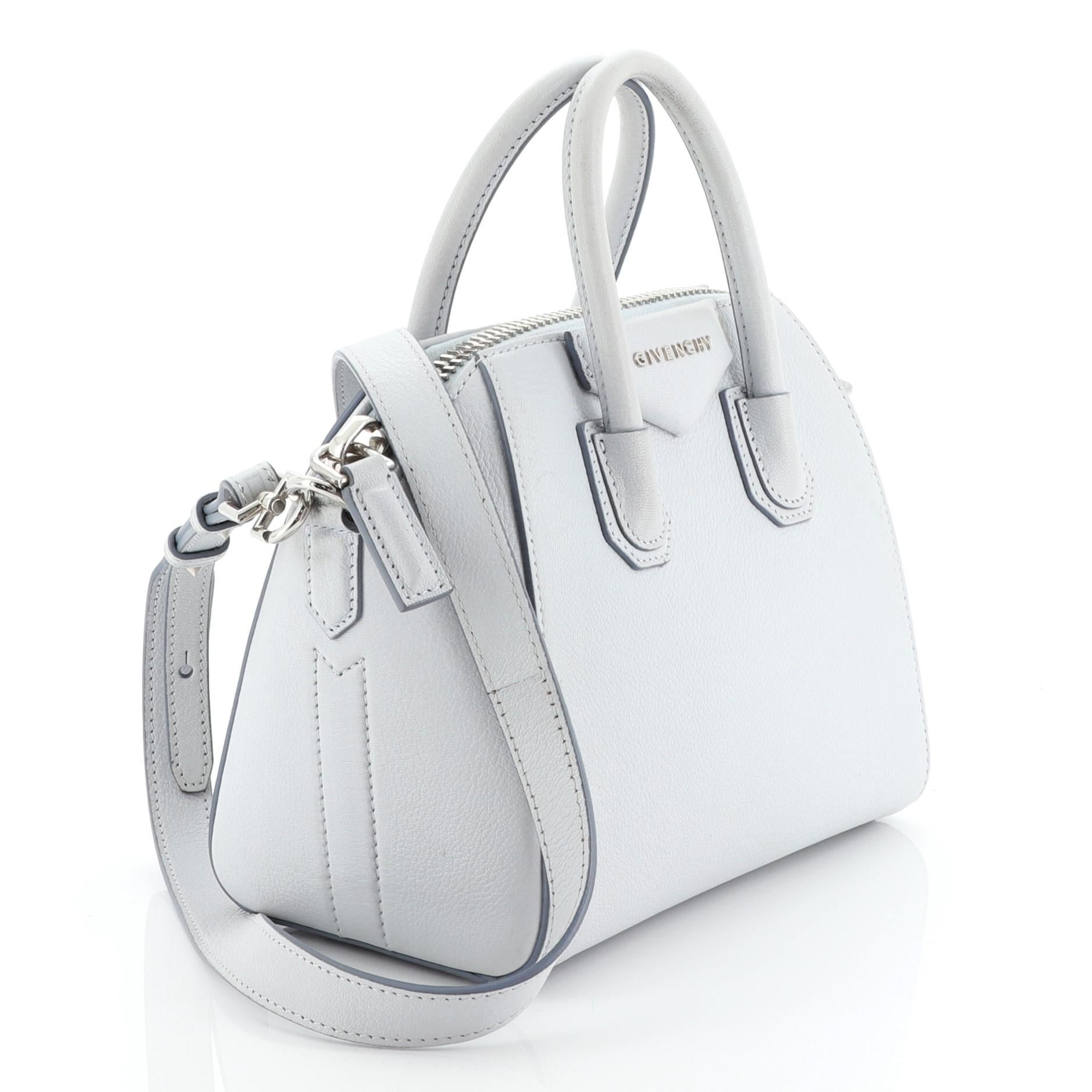 This Givenchy Antigona Bag Leather Mini, crafted from blue leather, features dual rolled leather handles and silver-tone hardware. Its zip closure opens to a neutral fabric interior with zip and slip pockets.

Estimated Retail Price: