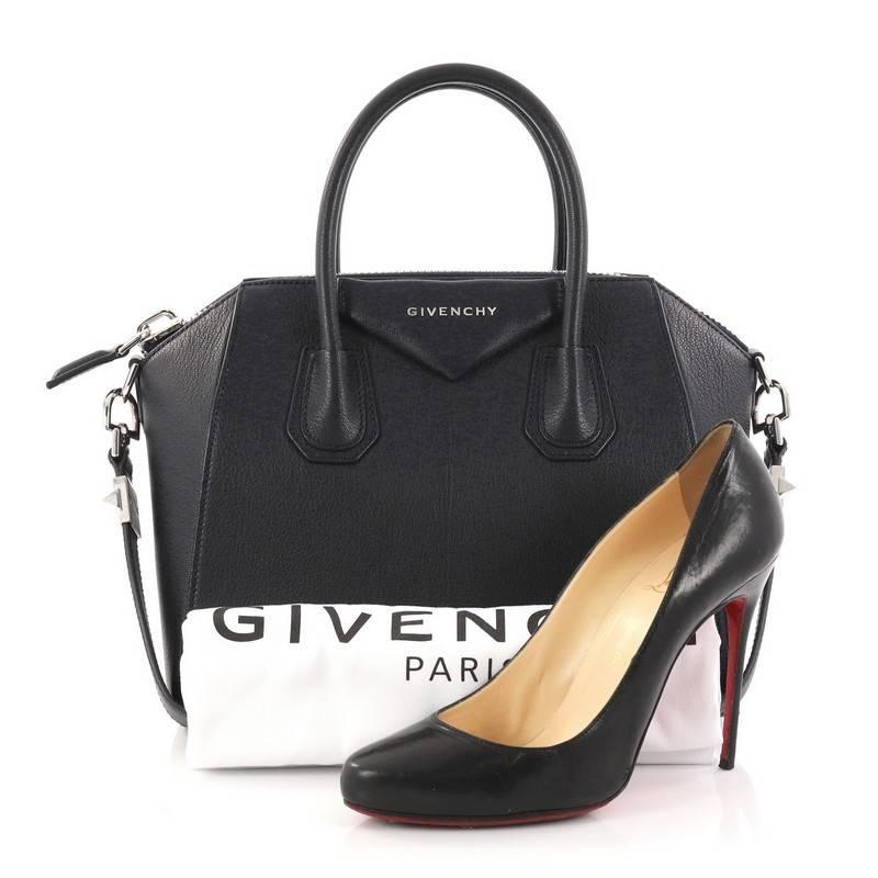 This authentic Givenchy Antigona Bag Leather Small combines style and functionality all-in-one. Crafted from navy leather, this structured handle bag is designed with the brand's signature envelope flap detail with silver Givenchy logo, dual-rolled