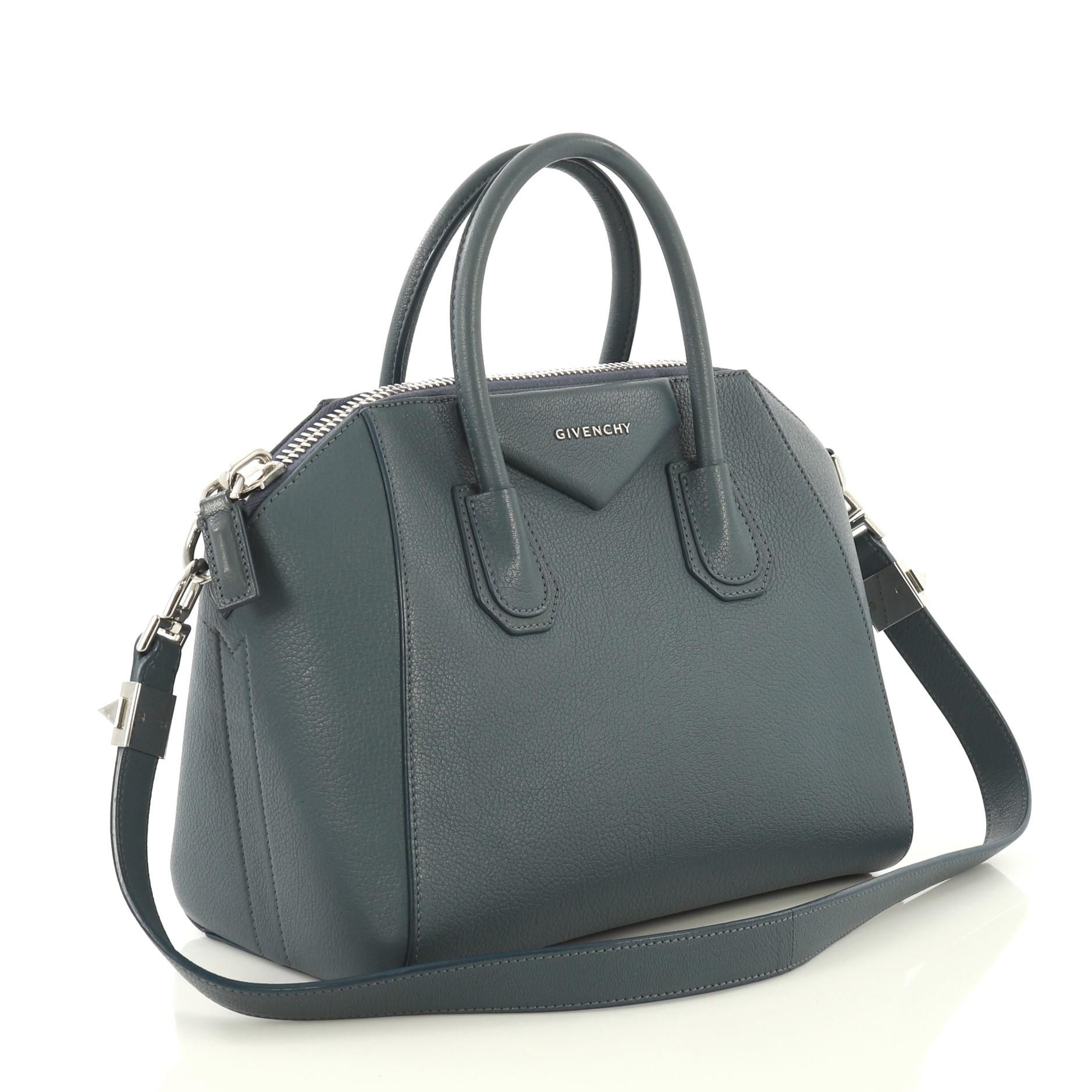 This Givenchy Antigona Bag Leather Small, crafted from blue leather, features dual rolled leather handles and silver-tone hardware. Its zip closure opens to a neutral fabric interior with zip and slip pockets. 

Estimated Retail Price: