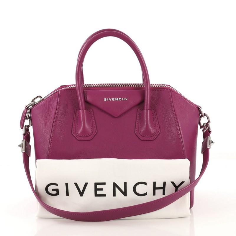 This Givenchy Antigona Bag Leather Small, crafted from purple leather, features dual rolled leather handles and silver-tone hardware. Its zip closure opens to a neutral fabric interior with zip and slip pockets. 

Estimated Retail Price: