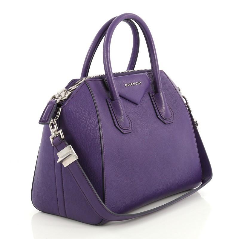 This Givenchy Antigona Bag Leather Small, crafted from purple leather, features dual rolled leather handles and silver-tone hardware. Its zip closure opens to a neutral fabric interior with zip and slip pockets. 

Estimated Retail Price: