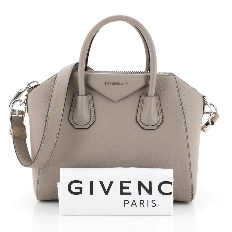 This Givenchy Antigona Bag Leather Small, crafted from neutral leather, features dual rolled leather handles and silver-tone hardware. Its zip closure opens to a black fabric interior with zip and slip pockets. 

Estimated Retail Price: