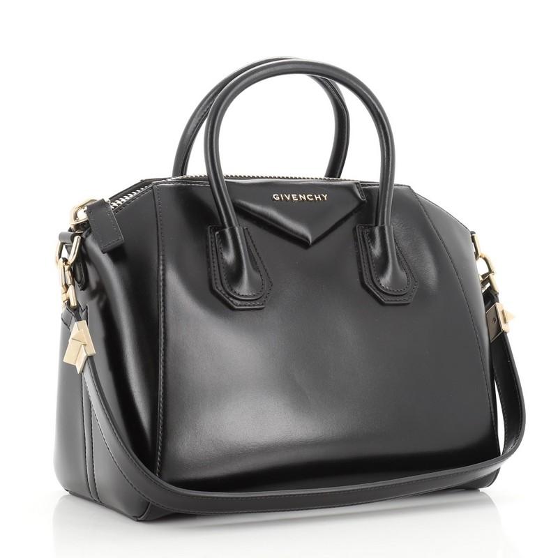 This Givenchy Antigona Bag Leather Small, crafted from black leather, features dual rolled leather handles and silver-tone hardware. Its zip closure opens to a black fabric interior with zip and slip pockets. 

Estimated Retail Price: