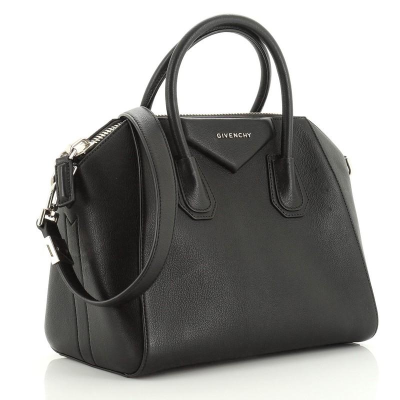 This Givenchy Antigona Bag Leather Small, crafted from black leather, features dual rolled leather handles and silver-tone hardware. Its zip closure opens to a black fabric interior with zip and slip pockets. 

Estimated Retail Price: