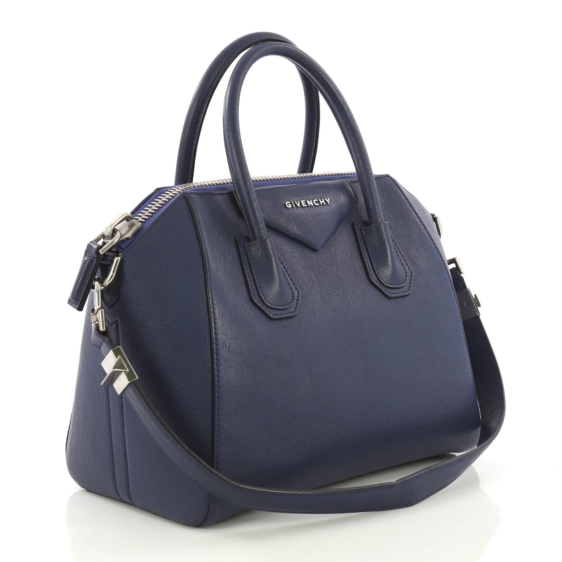 This Givenchy Antigona Bag Leather Small, crafted from blue leather, features dual top handles, and silver-tone hardware. Its top zip closure opens to a beige fabric interior with side zip and slip pockets. **Note: Shoe photographed is used as a