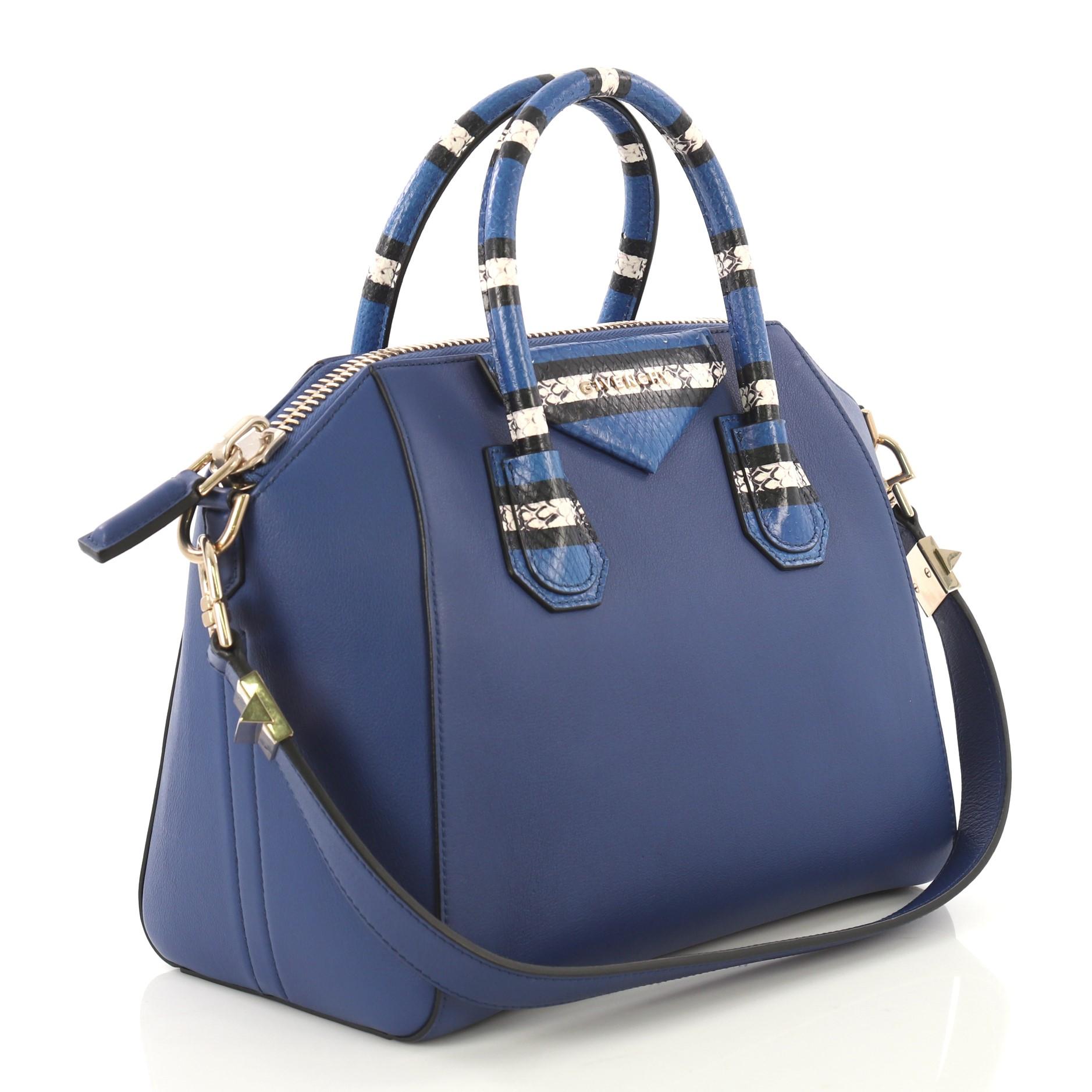 This Givenchy Antigona Bag Leather with Snakeskin Detail Small, crafted from blue leather with snakeskin detail, features dual rolled genuine snakeskin handles and gold-tone hardware. Its zip closure opens to a black fabric interior with zip and