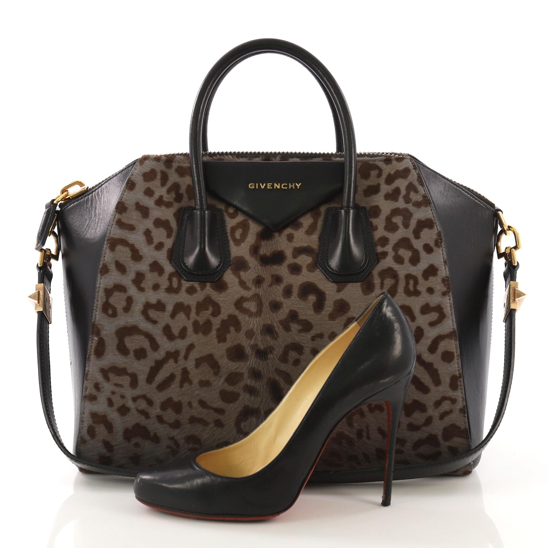 This Givenchy Antigona Bag Pony Hair Medium, crafted from brown pony hair, features dual rolled leather handles and gold-tone hardware. Its zip around closure opens to a black fabric interior with zip and slip pockets. **Note: Shoe photographed is