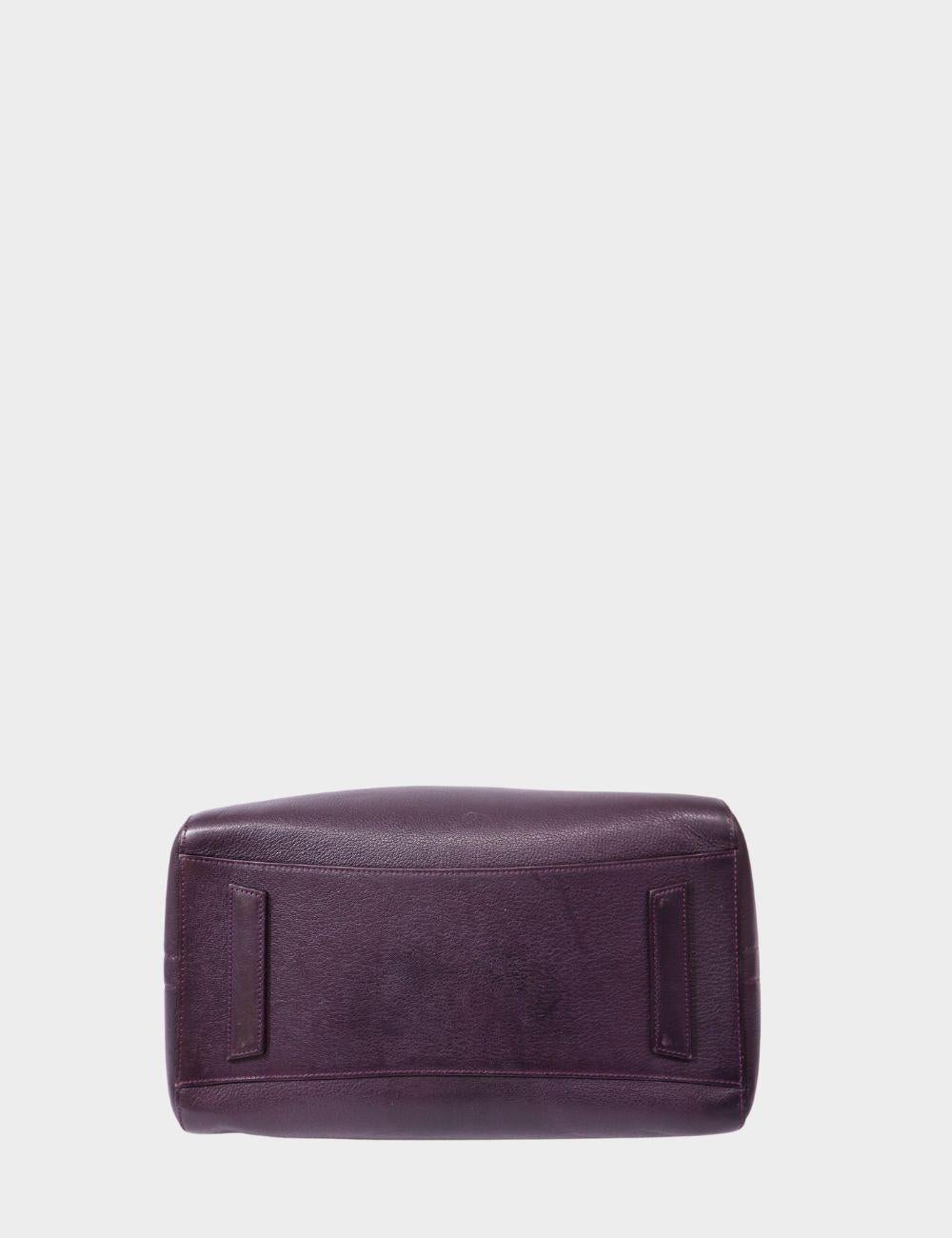 Elevate your everyday with the iconic Givenchy Antigona Medium Satchel in deep plum leather. Known for its architectural structure and timeless elegance, this designer bag features top handles and a detachable shoulder strap for versatile carry. Its