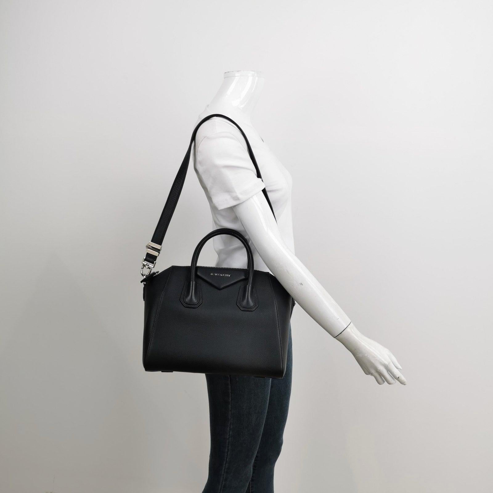 Givenchy Antigona Small Black Calfskin Leather Top Handle bag with Strap
 These are professional photos of the actual bag offered by Luxbags.
 This iconic design boasts a roomy interior, perfect for carrying all your essentials. Crafted with