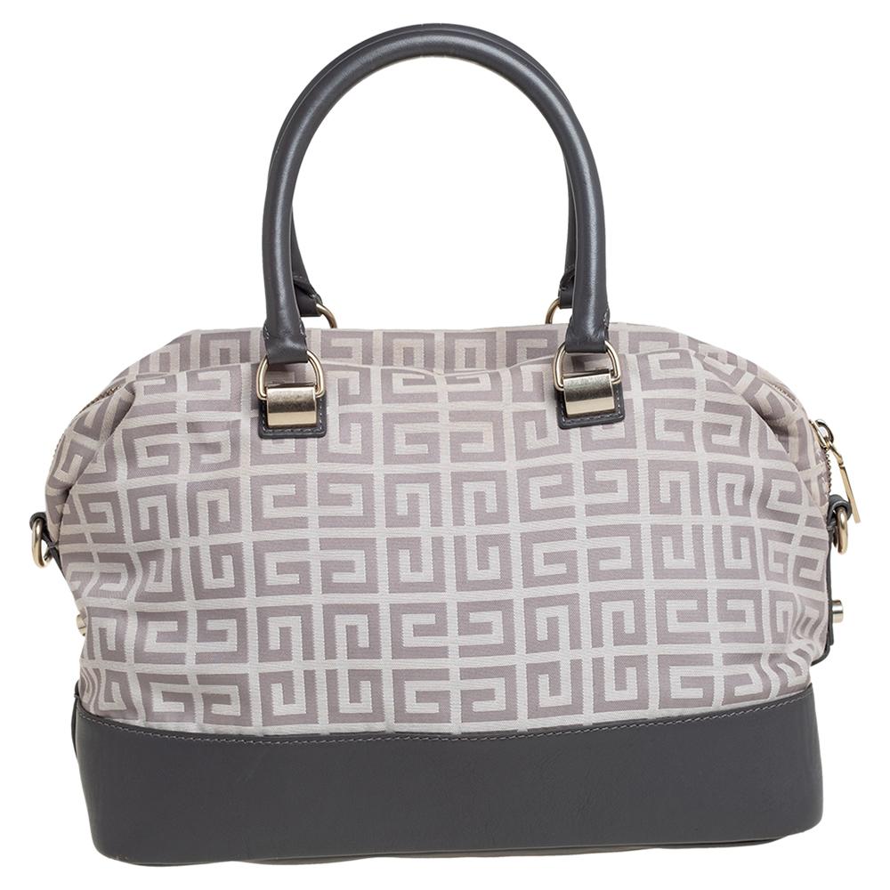 This Givenchy satchel in monogram canvas and leather has an alluring design. Beautifully crafted, the bag comes with a highly durable exterior, a spacious fabric interior, two handles, and the brand detail on the front. The creation is ideal for