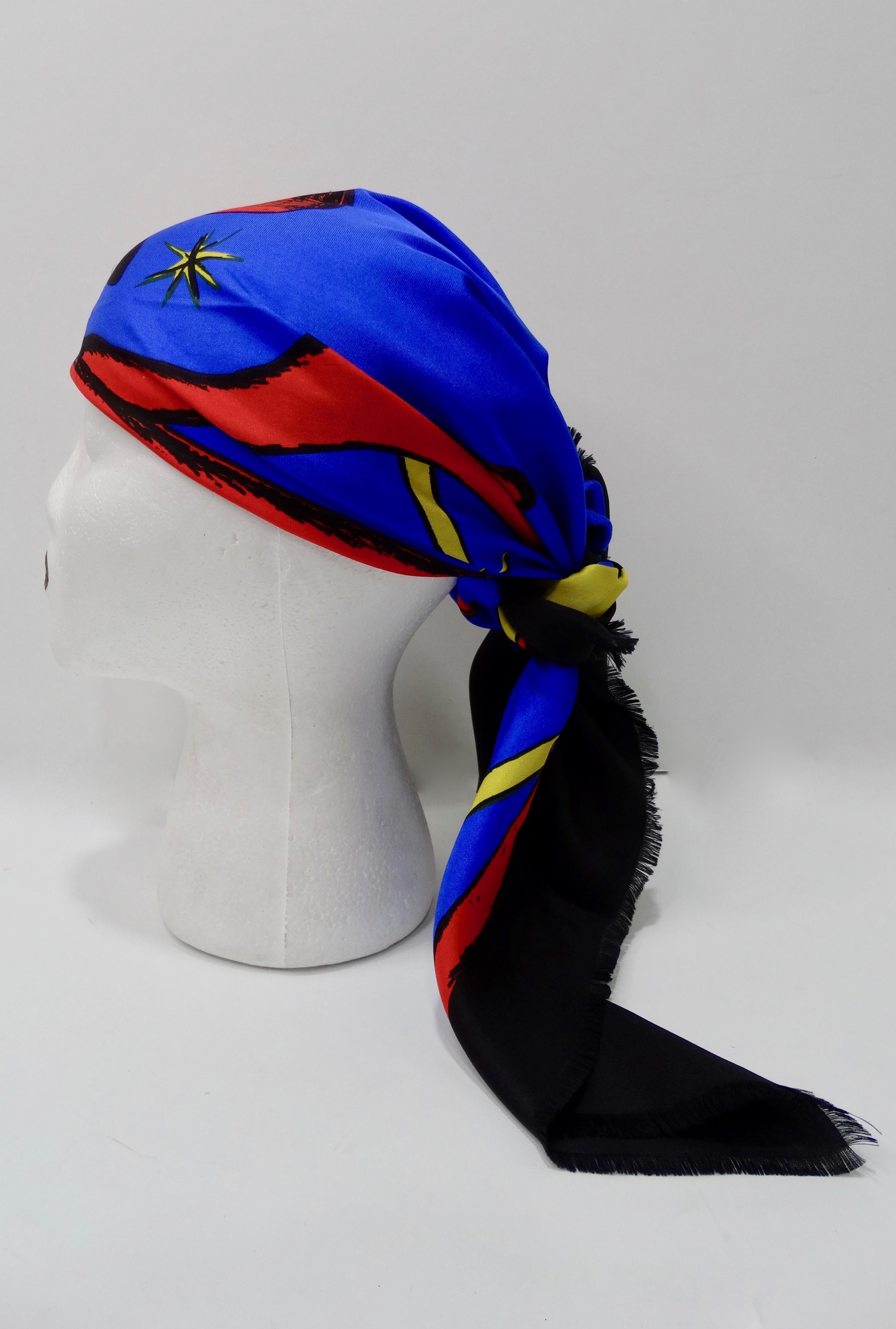 Take the holiday spirit with you every where you go with this amazingly rare Givenchy scarf! Circa 1980s, rendered in black, blue, gold and red this Silk scarf features a reindeer motif accented with candles and stars. Includes 'Best Wishes'