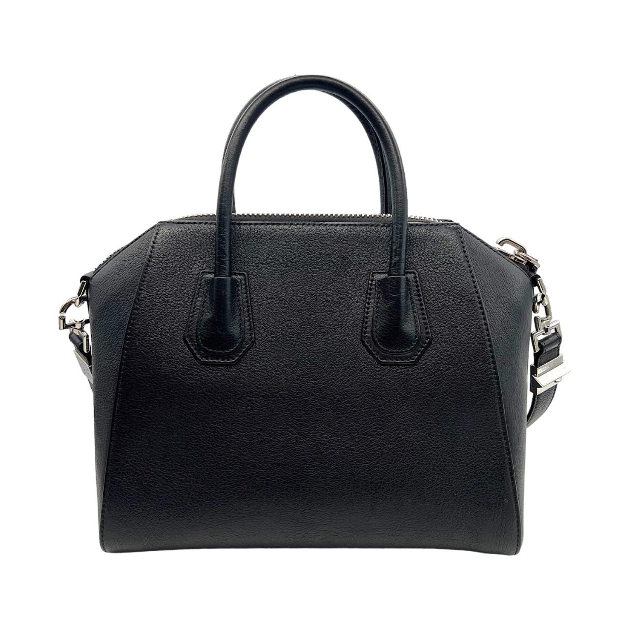We are offering this black Givenchy Antigona handbag. Made in Italy, it is finely crafted of a black calfskin leather exterior with a 'GIVENCHY' logo in silver-tone hardware. It has dual calfskin leather rolled handles and a removeable shoulder