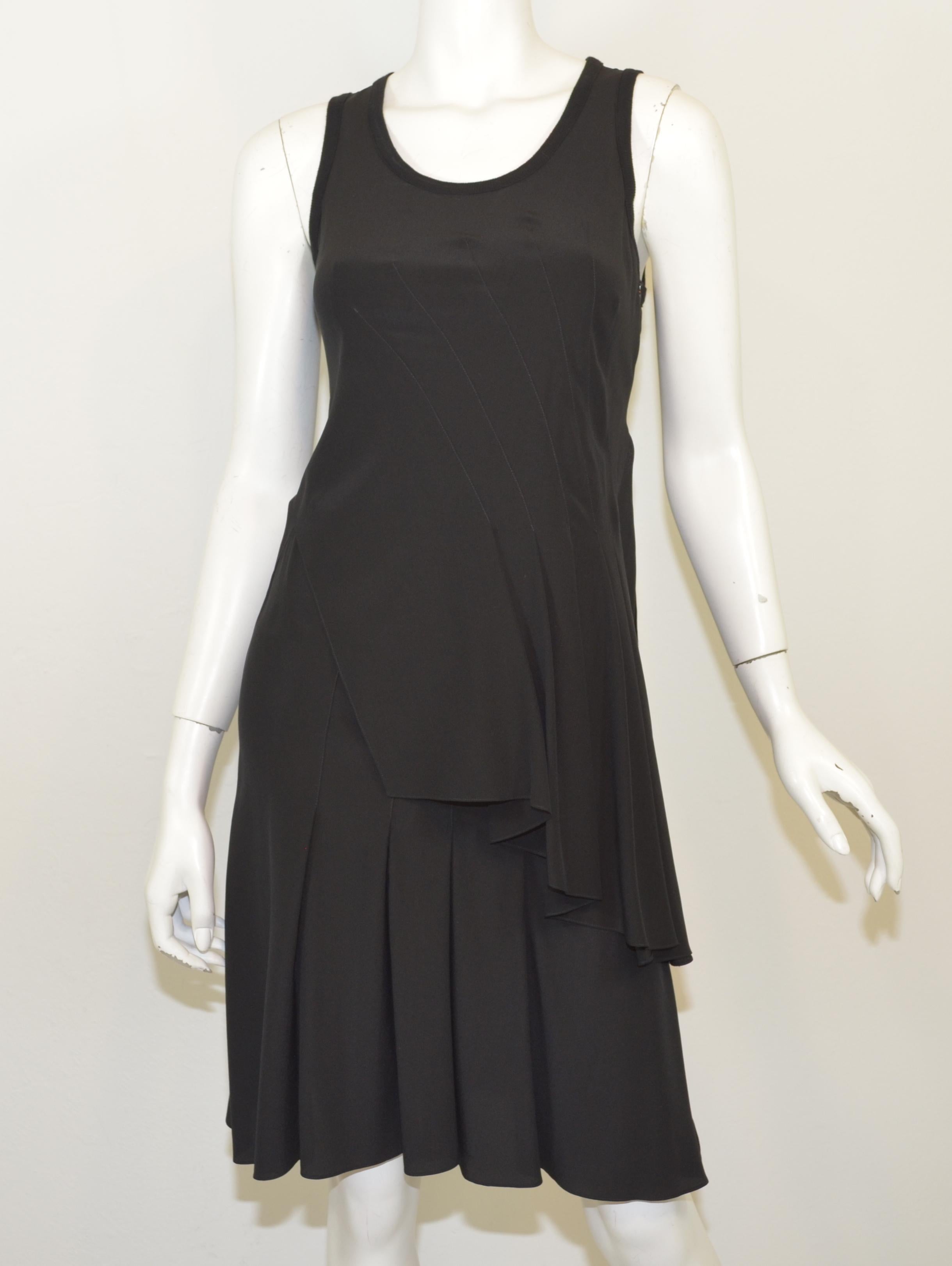 Givenchy black dress 100% silk features an asymmetric pleated design throughout with a knit trim collar, and has a side zipper closure. Dress is a size 38, Made in Italy

Measurements: bust 32'', waist 30'', hips 34'', length 39''