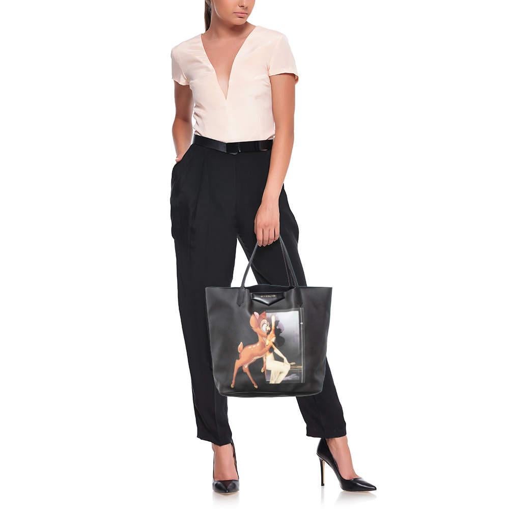 This shopper tote from Givenchy is a creation meant to assist you with style and ease. It comes crafted from black coated canvas & leather. The label is flaunted on the front with a Bambi print, two handles are provided for you to carry it and a