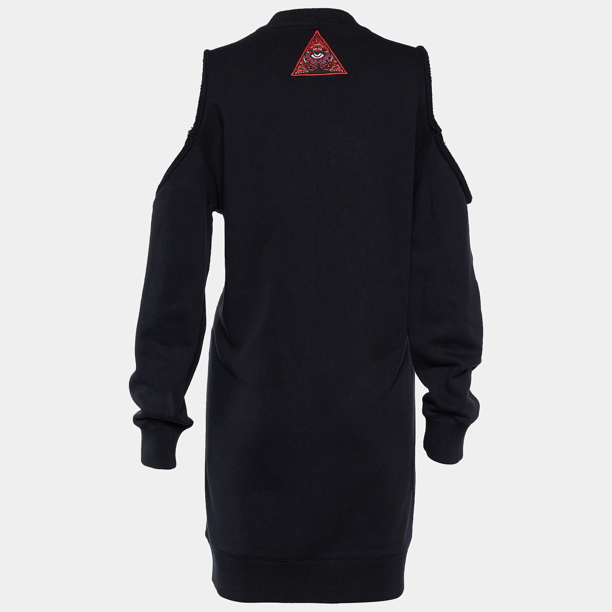 Make a classy fashion statement as you wear this shift dress from the House of Givenchy. Tailored using black cotton fabric, the back of this dress is embellished with multicolored eye embroidery. It is further enhanced with cold-shoulder detailed