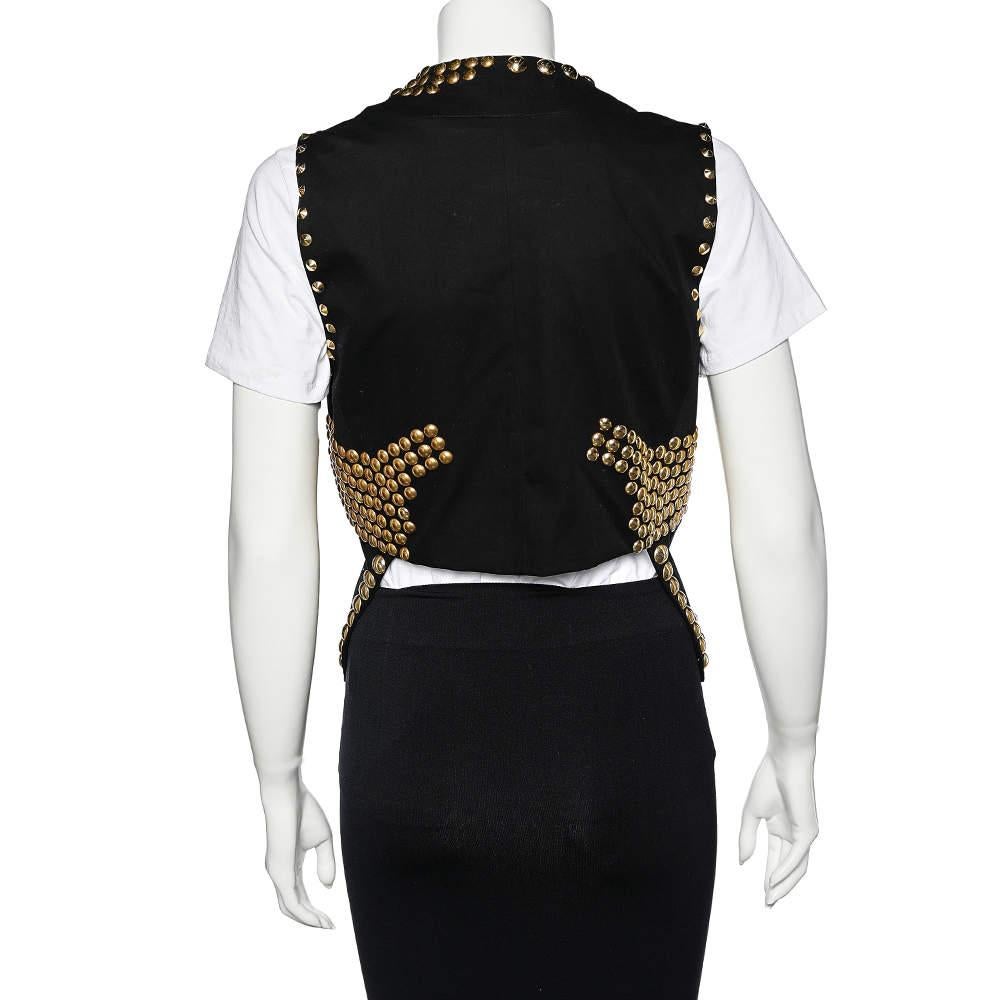 This shrug from the House of Givenchy is absolutely beautiful and will complement your style well. It is tailored using black cotton fabric, which is embellished with gold-toned studded accents. It has a cropped silhouette. With this fabulous piece,