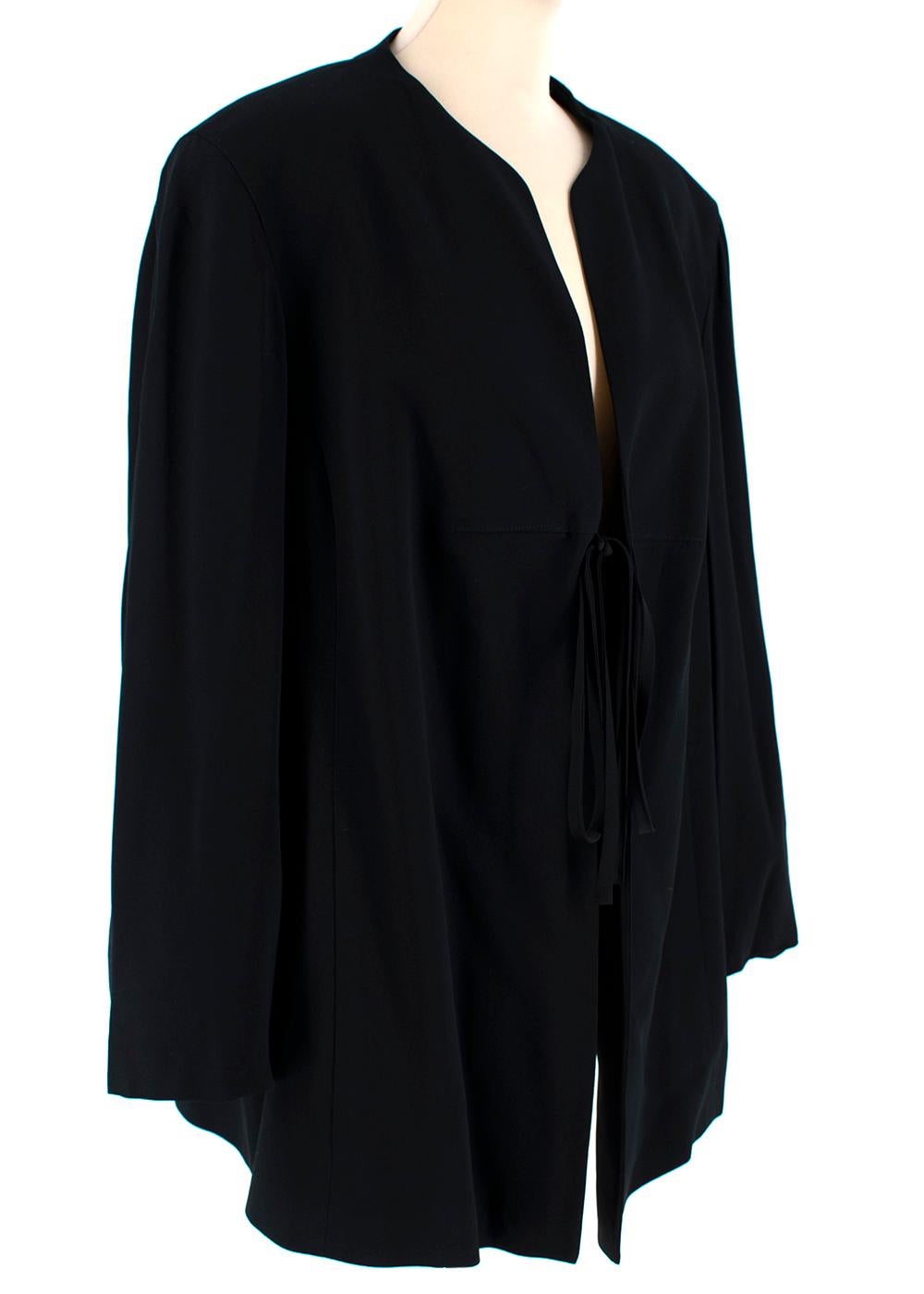 Givenchy Black Crepe Front Tie Collarless Vintage Jacket

- Made of soft crepe fabric 
- Classic cut 
- Collarless 
- Tie up fastening to the front 
- Neutral black hue 
- Elegant versatile design 

Materials:
57% viscose, 43% acetate

Dry clean