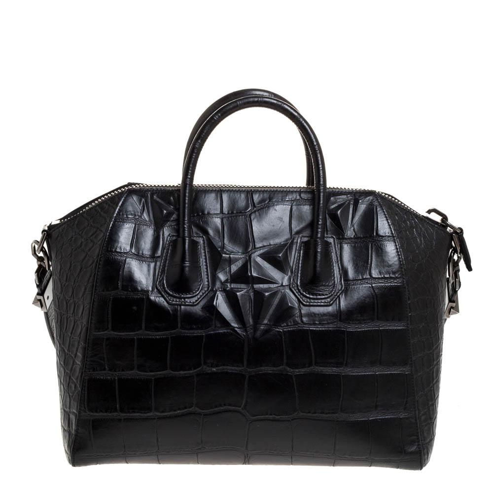 Made in Italy, and loved by women worldwide is this beautiful Antigona satchel by Givenchy. It has been crafted from croc-embossed leather and shaped elegantly. The black bag has a top zipper that reveals a fabric interior and it is held by two top