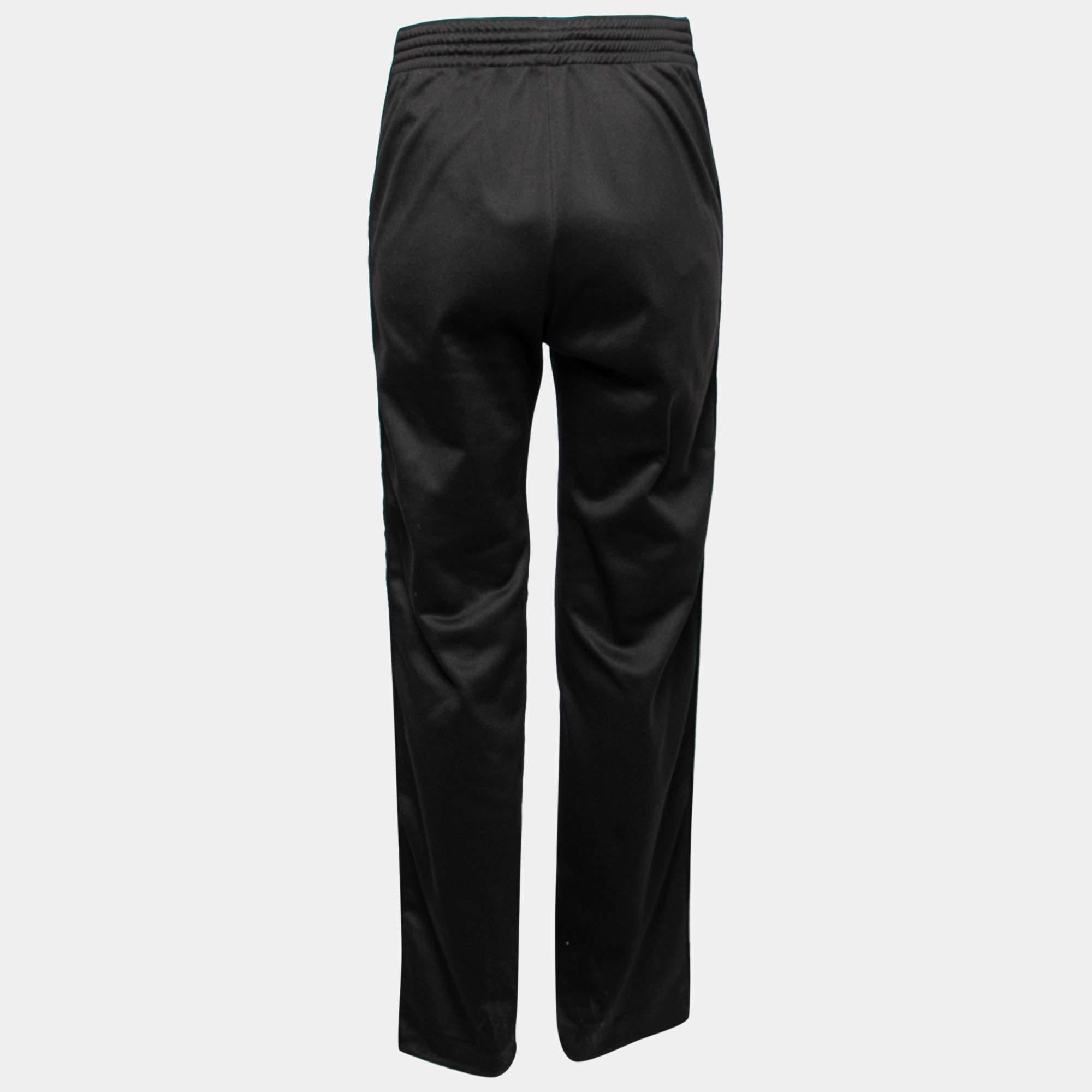 Spend the day comfortably and stylishly with these joggers from the House of Givenchy. They are made from black jersey fabric, with logo tape trims detailing the sides. They have two external pockets. Add these classy joggers to your collection