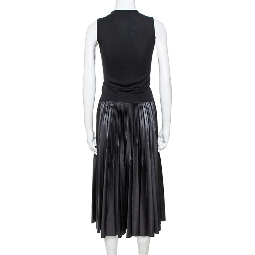 Turn heads when you wear this Givenchy dress that lends a sophisticated edge to your personality. This black dress is designed with a sleeveless bodice and a pleated faux leather skirt. Dress up in this jersey dress that lends a free-flowing
