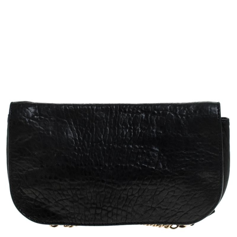 The clutch by Givenchy is a creation that is not only stylish but also exceptionally well-made. Meticulously crafted from leather, it flaunts a black shade and a logo-detailed flap that leads to a canvas interior. High on style and design, this