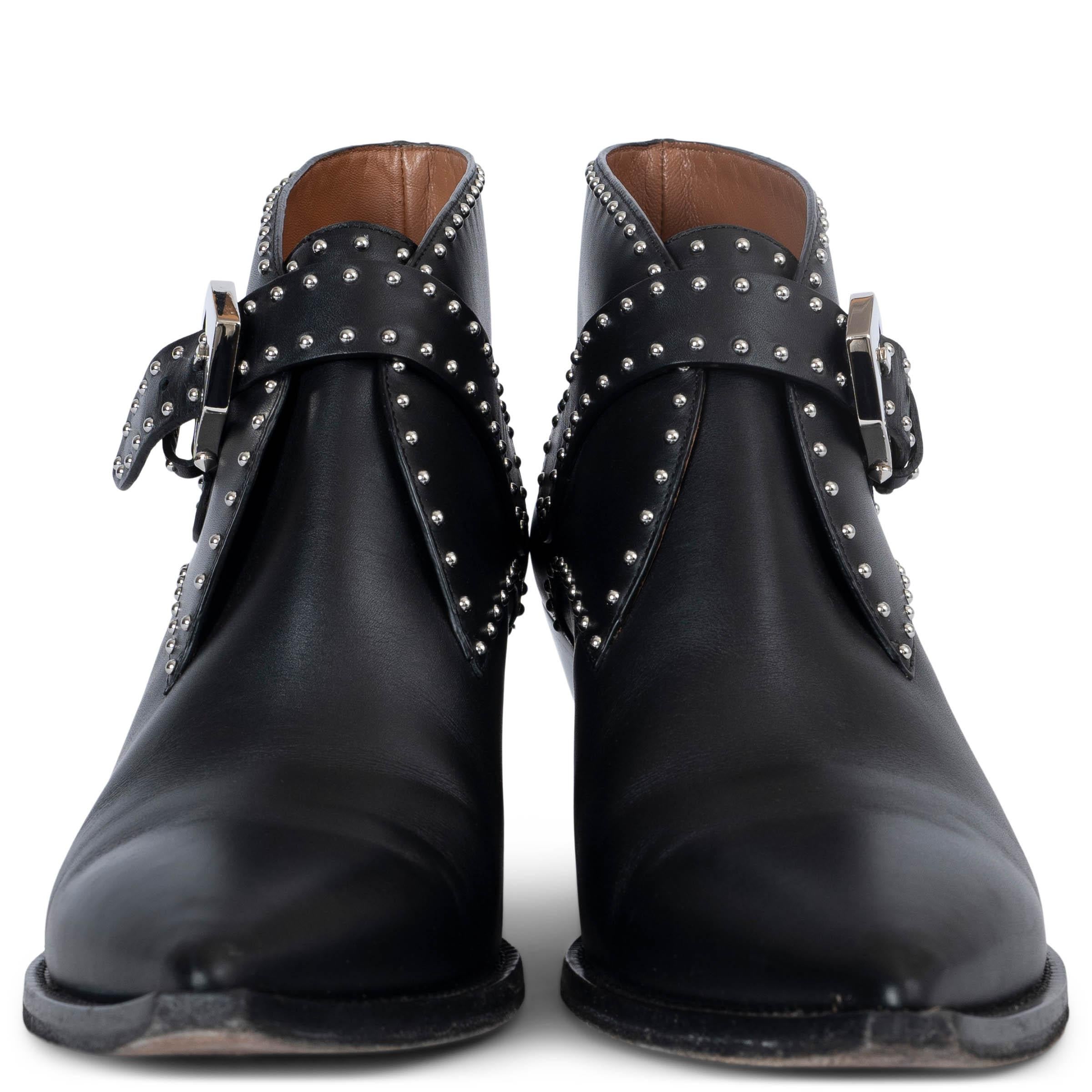 These 100% authentic Givenchy Elegant ankle western boots are crafted from black leather, offering a bold pointed-toe design and a classic Cuban heel for a sleek, modern western-inspired look. Featuring mini studs and a stylish belt closure, these