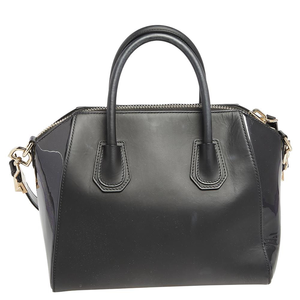Made in Italy, and loved by women worldwide is this beautiful Antigona satchel by Givenchy. It has been crafted from patent and leather and shaped elegantly. The black bag has a top zipper that reveals a canvas interior and it is held by two top