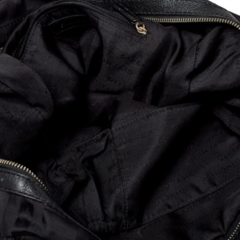 Spacious and captivating, this duffel bag is from Givenchy. It has been crafted from their signature canvas and leather with silver-tone hardware. It is equipped with a well-sized fabric interior and two handles for you to carry it with.
