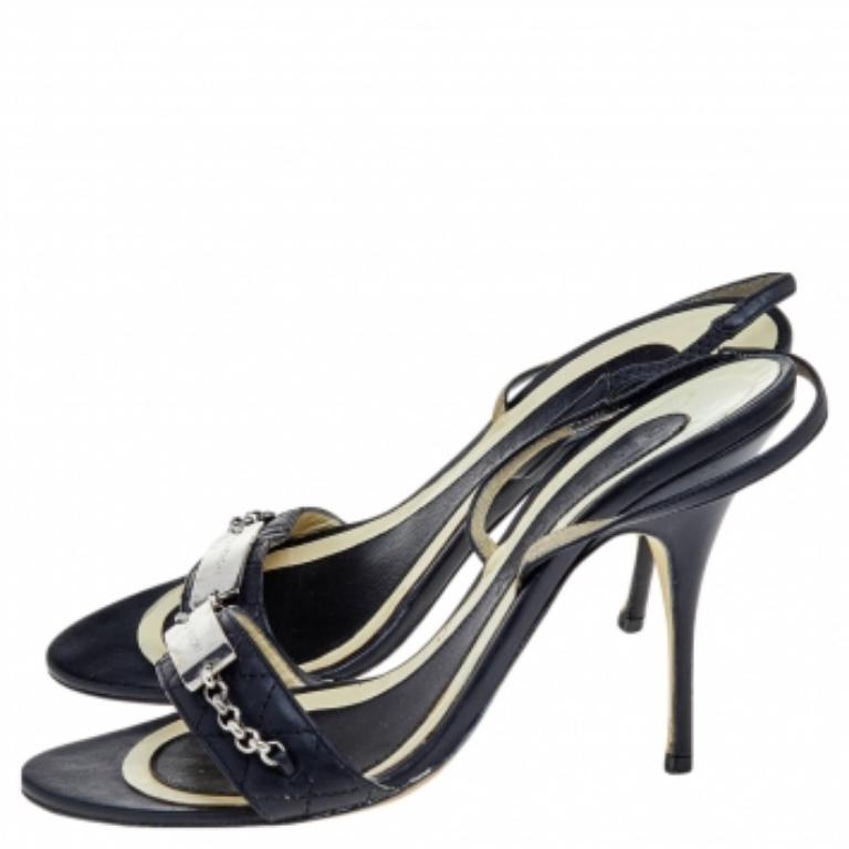¡Mima tus pies con estas elegantes sandalias de la Casa Givenchy! Están confeccionados en piel negra en el exterior y llevan puntera abierta, herrajes plateados y una tira en el tobillo. Se completan con tacones finos. ¡Combínalas con tu atuendo y