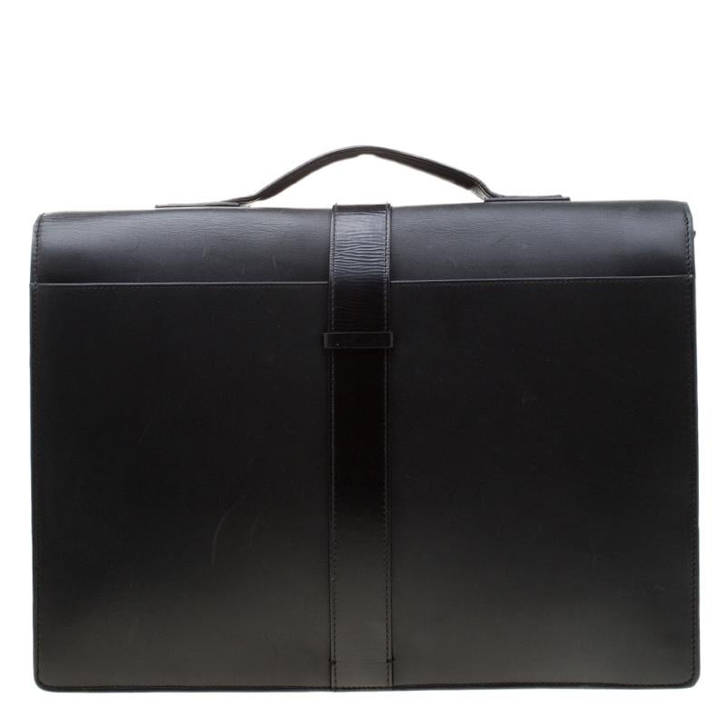 A practical bag for work and meetings, this briefcase from Givenchy will be your best companion. It features a minimal, fuss-free construction crafted from a black leather body and secured with buckle closure on the front flap. It comes fitted with