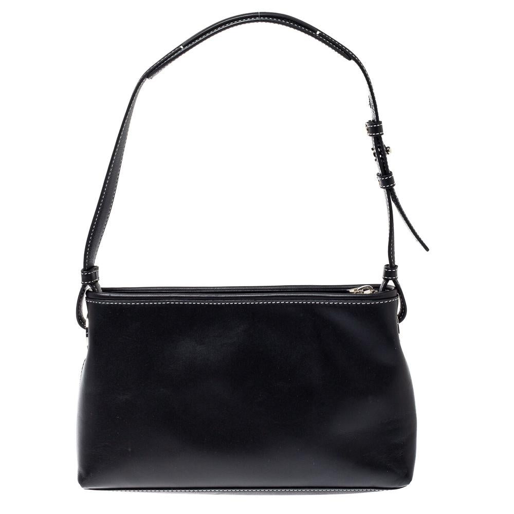 Known for quality and style, this elegant Givenchy handbag will display your subtle sense of fashion. It is crafted from leather and features a front flap pocket, a single handle strap, and silver-tone hardware. The interior of this gorgeous bag is