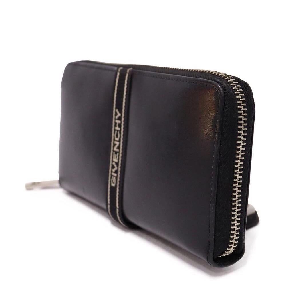 Givenchy Black Leather Logo Wallet , features eight card pockets, two slip, and one zipper and three compartments.

Material: Leather
Height: 9cm
Width: 19cm
Depth: 2.5cm
Overall condition: Fair
Interior condition: Stains
External condition: Leather