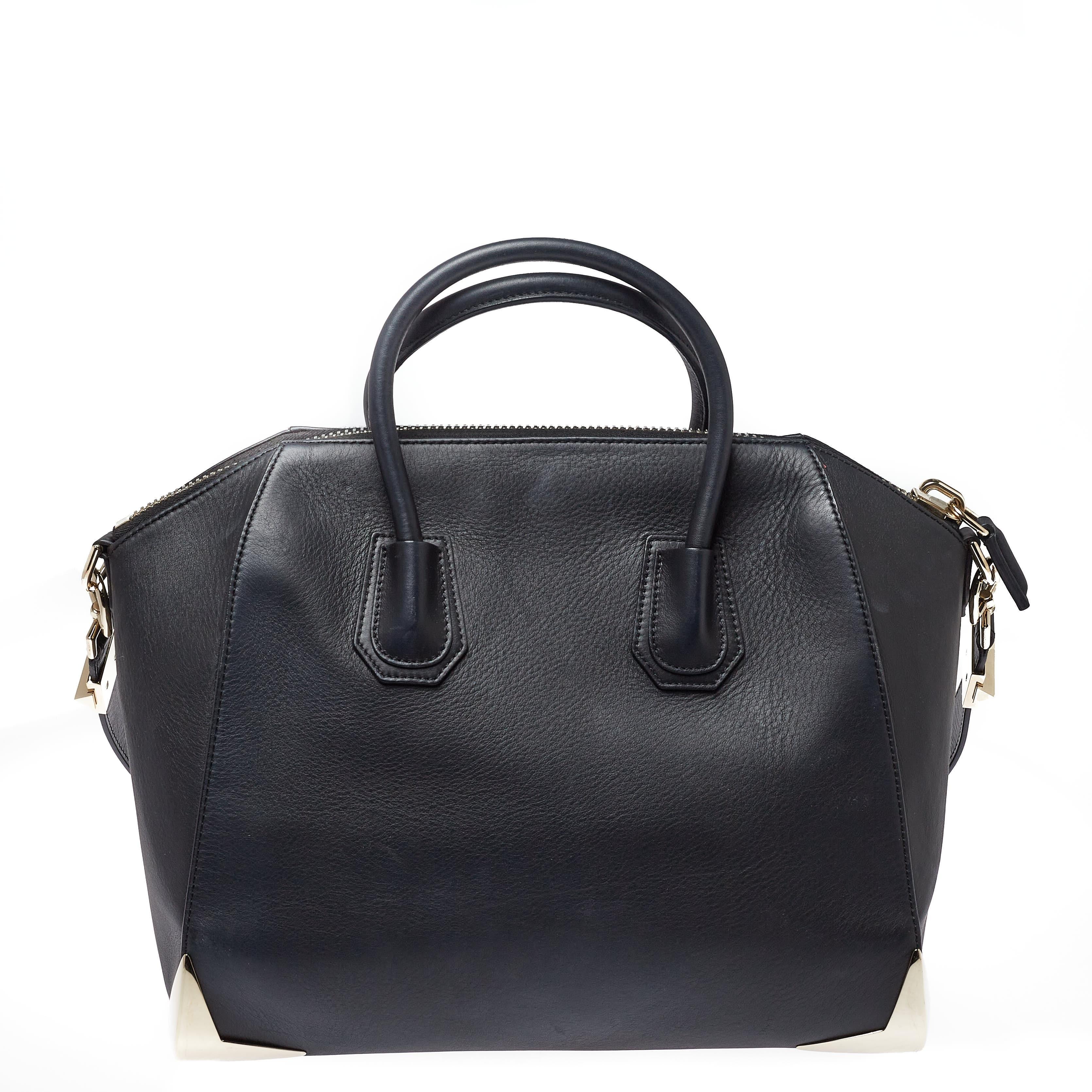 Made in Italy, and loved by women worldwide is this beautiful Antigona satchel by Givenchy. It has been crafted from leather and shaped elegantly. The black bag has metal detailing and a top zipper that reveals a fabric interior and it is held by