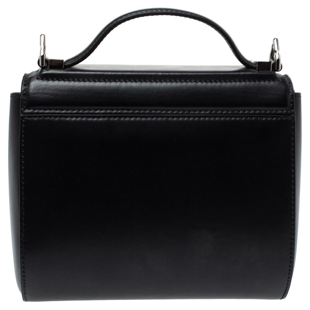 A new spin on Givenchy's original Pandora bag, this Givenchy Mini Pandora Box crossbody bag is crafted from black leather. While the suede compartment offers plenty of storage for your valuables, the shoulder strap and top handle lend ease. It is