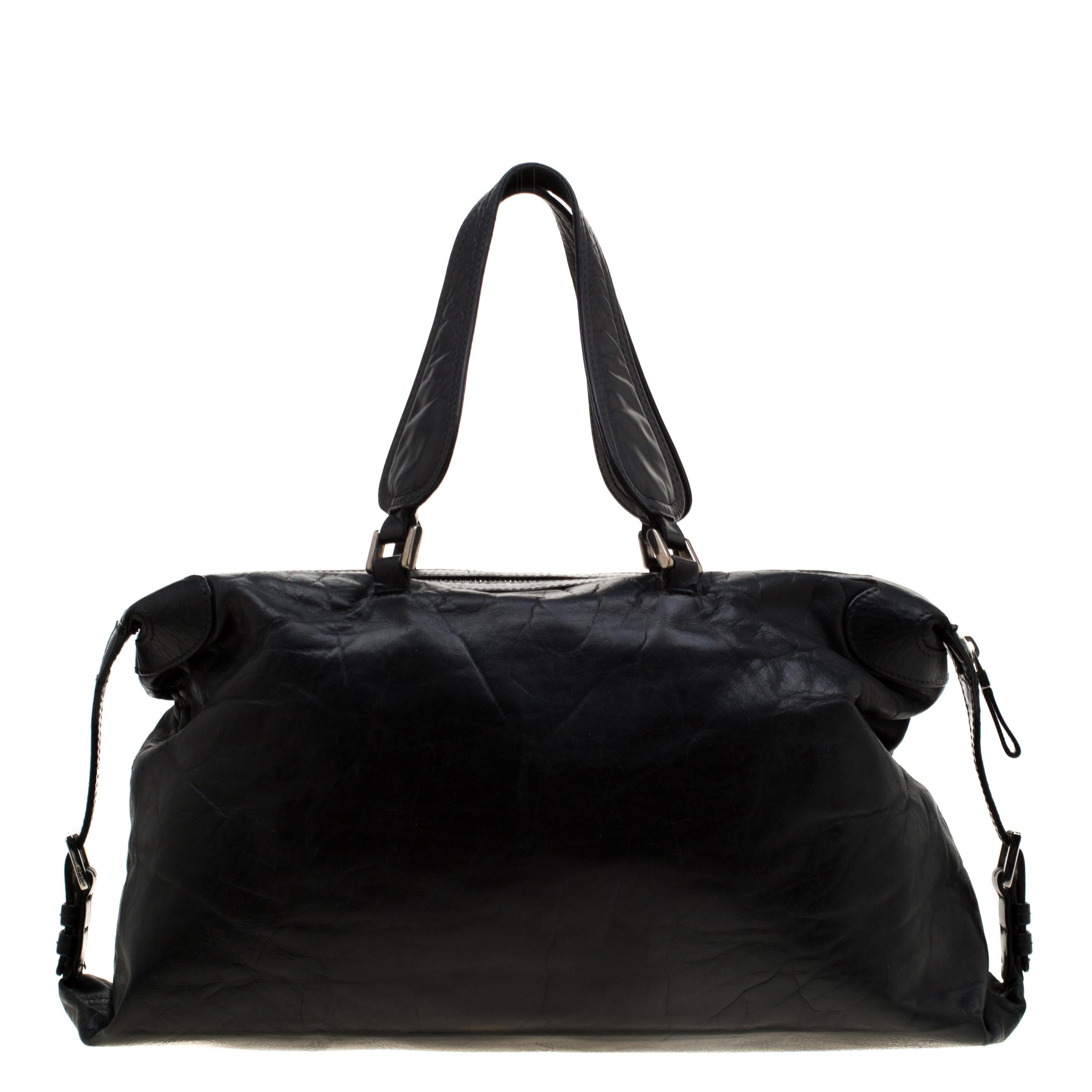 Excellently crafted from black leather for a classy touch, this Nightingale bag from Givenchy is a creation that is ideal for daily use and on your travels. It features the logo on the front, two top handles, a shoulder strap, and a spacious fabric