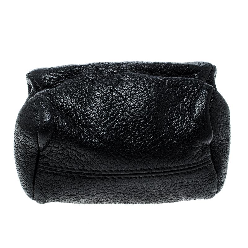 Equal parts fun and functional, this Givenchy purse is crafted in a durable black leather body and features two zipper openings. It features a fabric-lined interior that can easily hold all your coins and little valuables. Slip it into your everyday