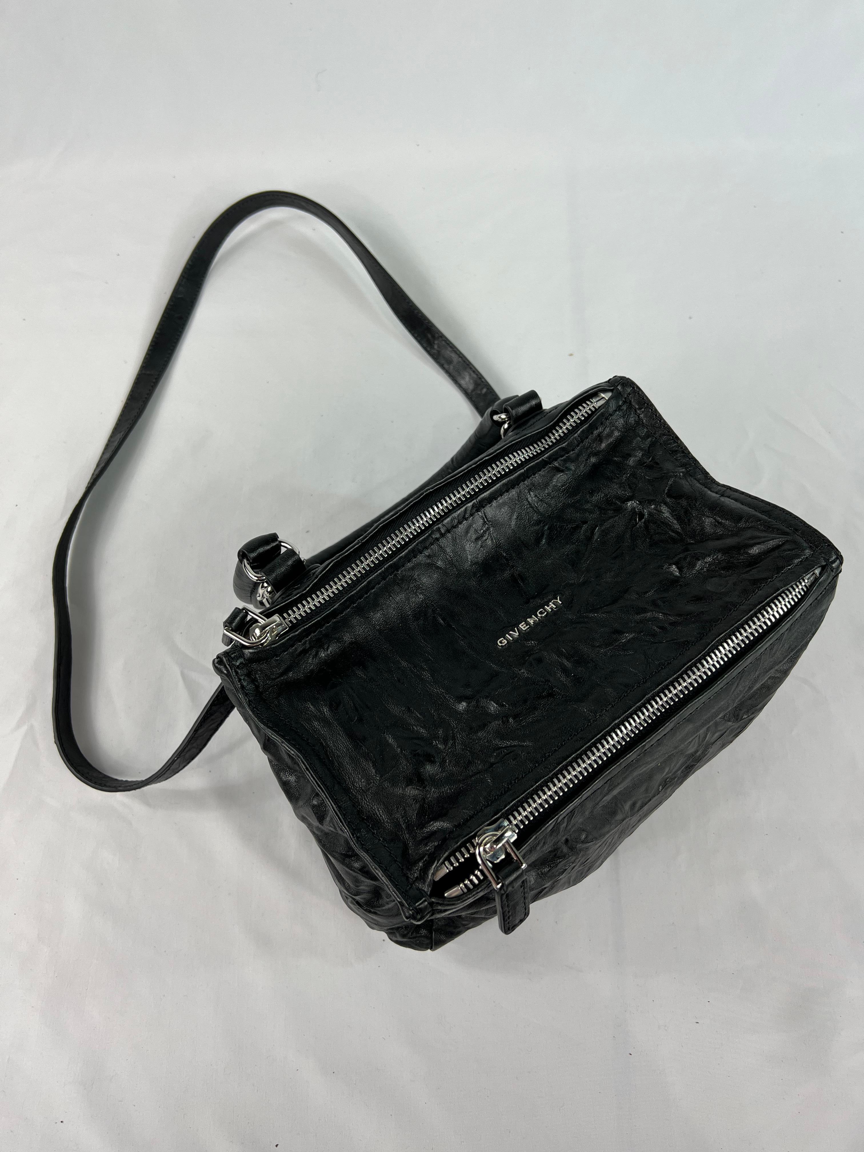Product details:

The purse is made out of soft crinkle leather. It features silver tone dual top zippers, one interior zipped pocked and two open interior pockets, removable shoulder strap, measures 24 inches long and top handle that drops 5.5